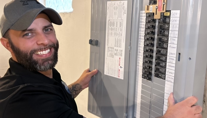 Smiling Technician With Electric Panel