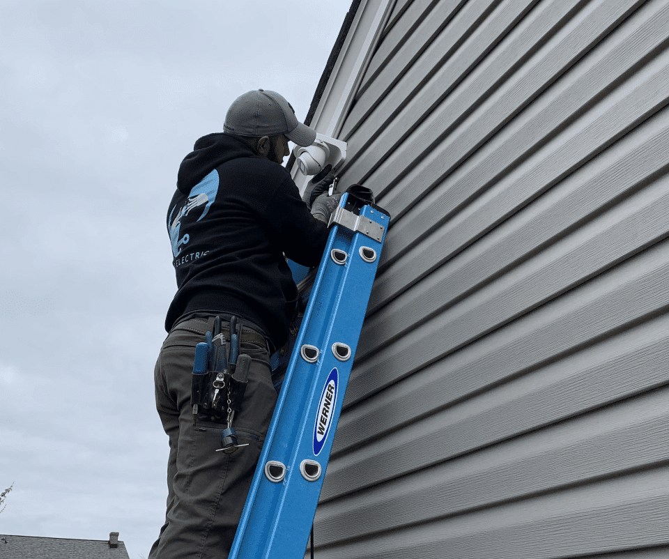 surge-electric-technician-installing-flood-lights