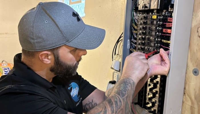 Surge Electric Technician Working On Panel Surge Electric Technician Working On Panel